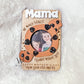 A hand holding a fridge photo magnet designed for Mother's Day, featuring a wooden frame with a cut-out shape of a cookie and the text 'MAMA, TOTALLY WOULD CRUMBLE WITHOUT YOU'.
