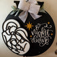 Decorative sign with nativity scene and 'O Night Divine' text on a black background.